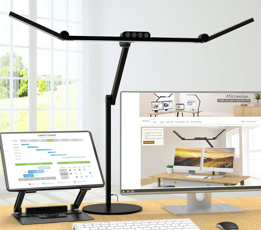 Modern productive home office setup featuring a smart LED desk lamp illuminating a desktop monitor and laptop on an ergonomic wooden desk.